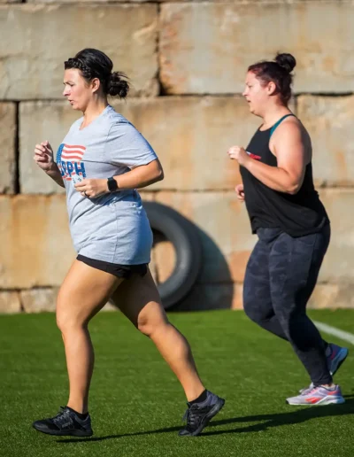 CFDHFMURPH-015 Two women running duirng CrossFit DHF training.