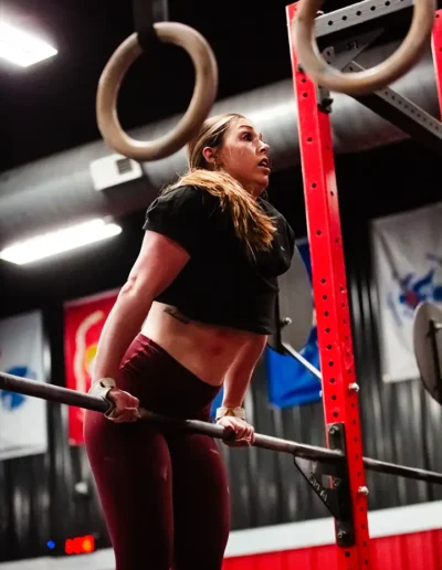 FNL-129 Woman on bars duirng CrossFit DHF training.