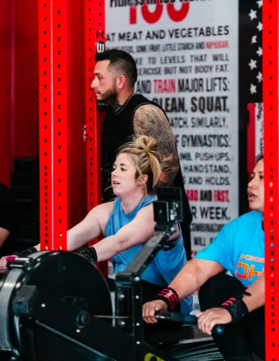 FNL-280 Group of people using exercise machines duirng CrossFit DHF training.