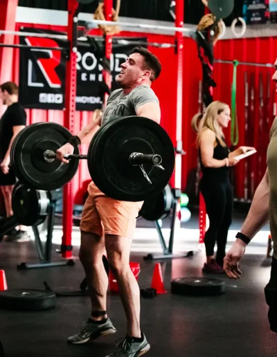 FNL-379 Men lifting weights duirng CrossFit DHF training.