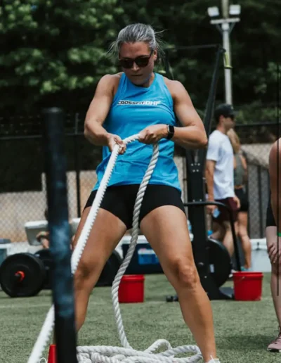 katie Fit senior woman pulls on ropes duirng CrossFit DHF training.