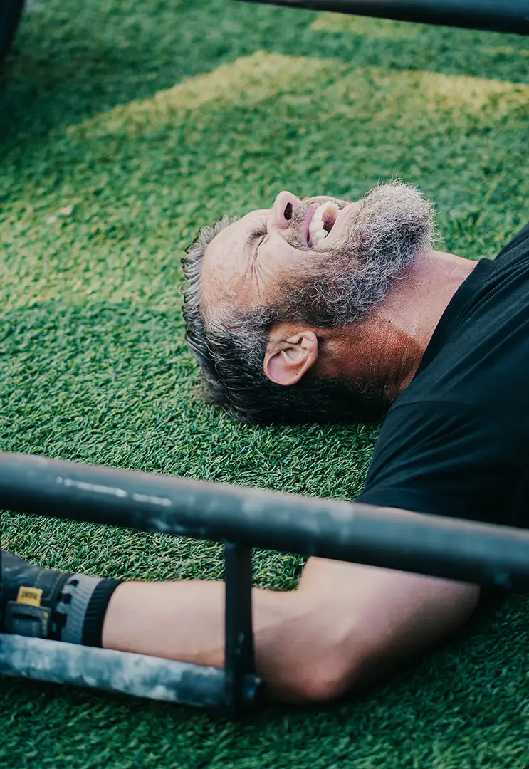A Fit Fest contestant lying on the grass laughing