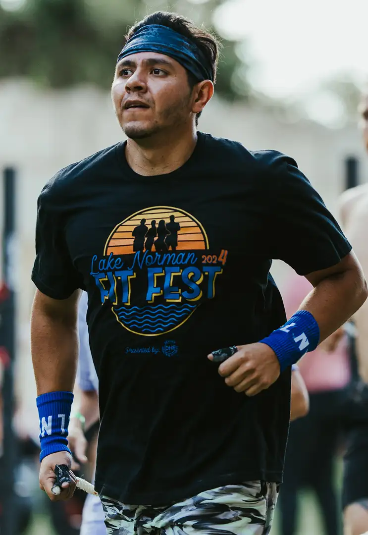 A man wearing a Fit Fest t-shirt competing in a race.