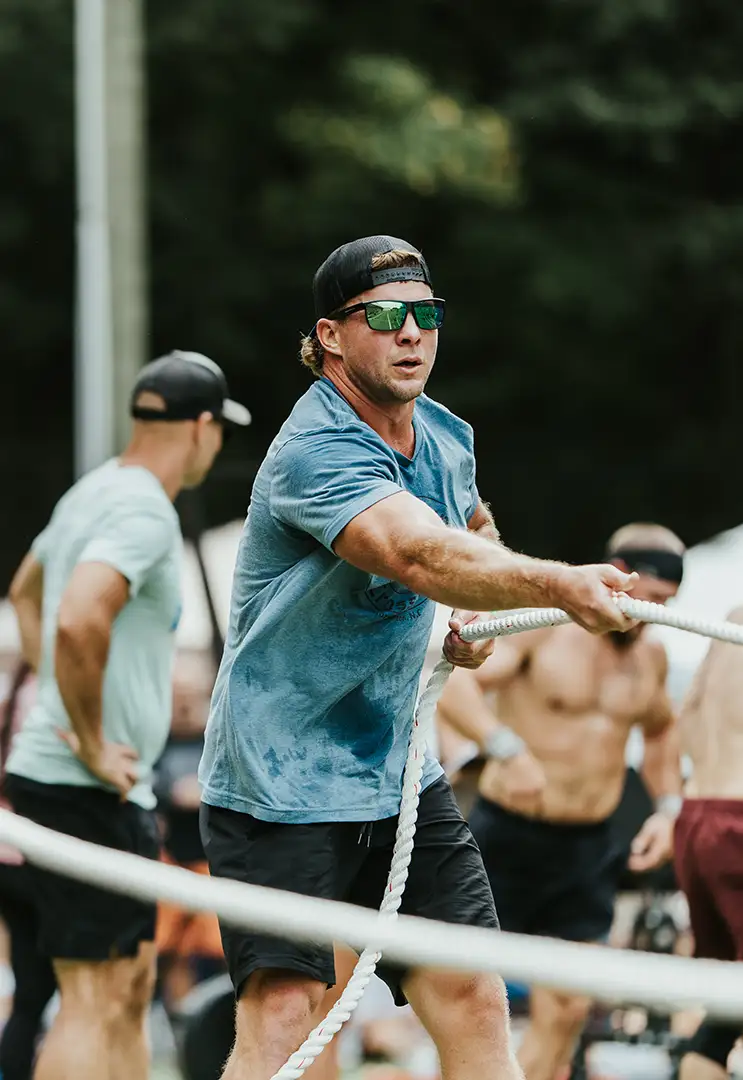A fit man pulling on a rope during a Fit Fest competition.