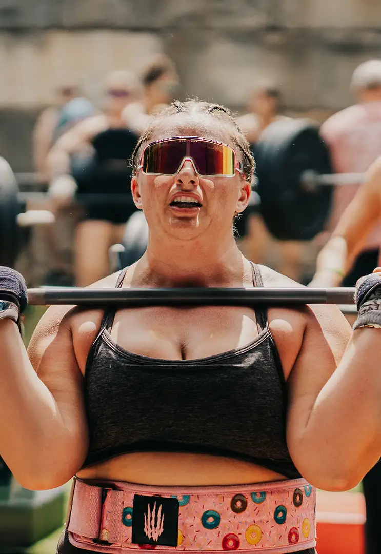 A strong woman lifting heavy weights.