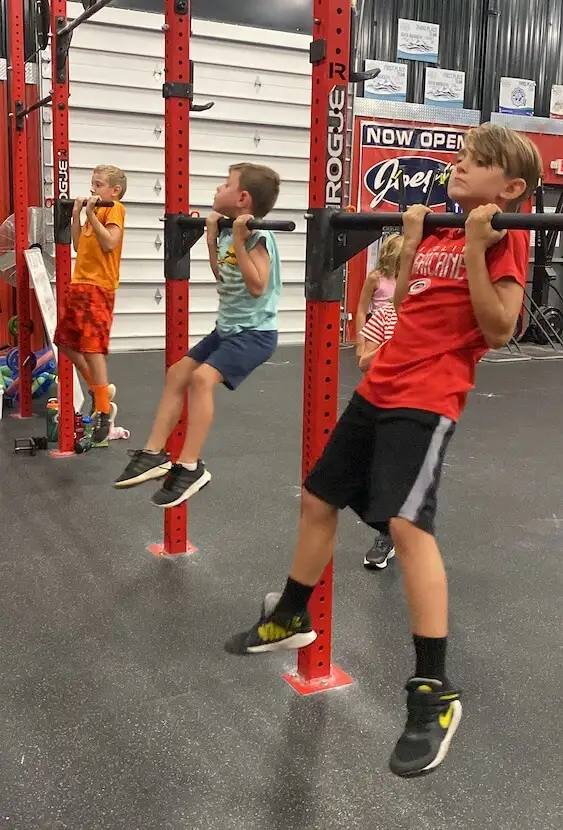 Kids doing chin lifts at DHF.