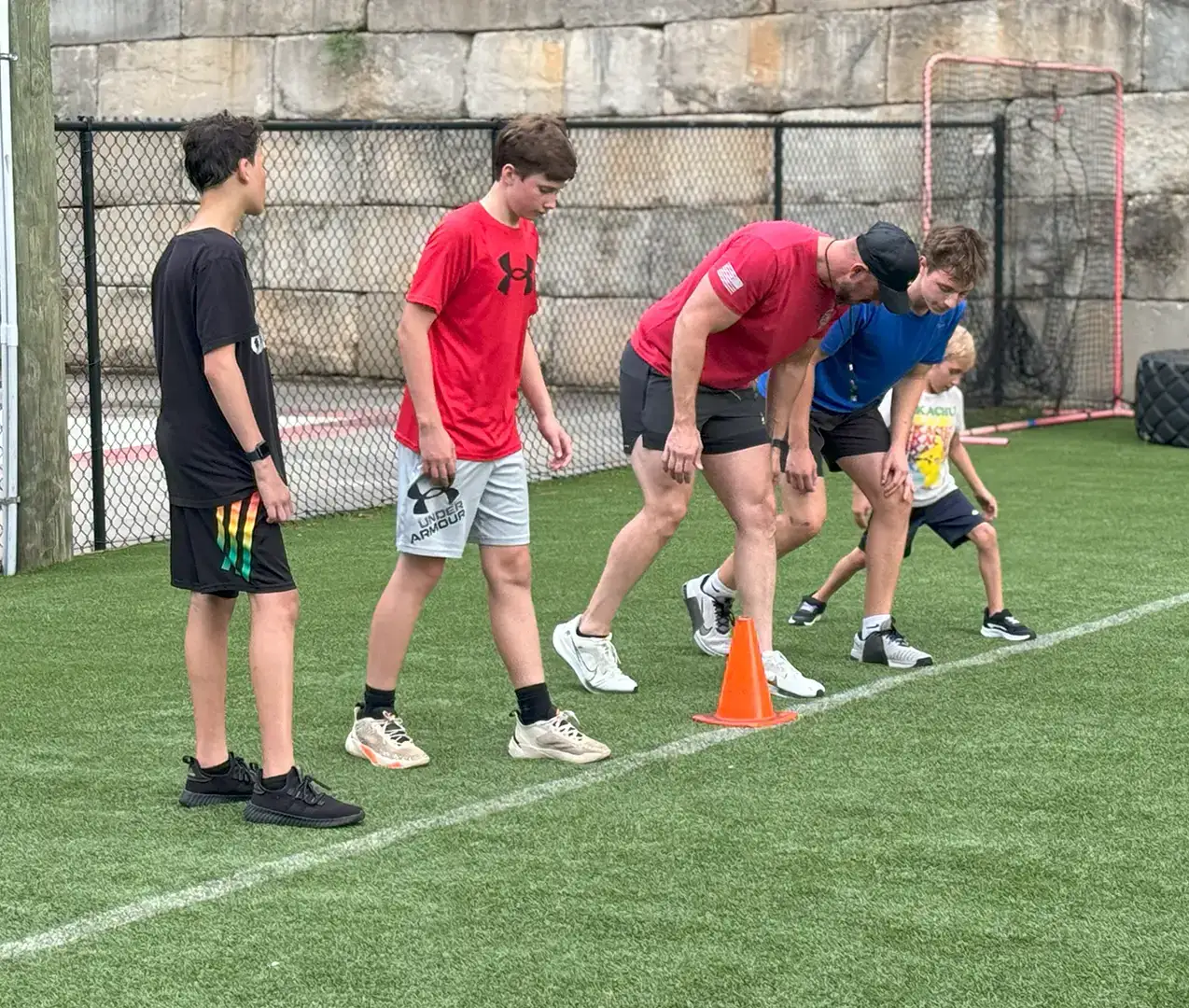 Athletics_4 A group of boys working with an Athletic Trainer.