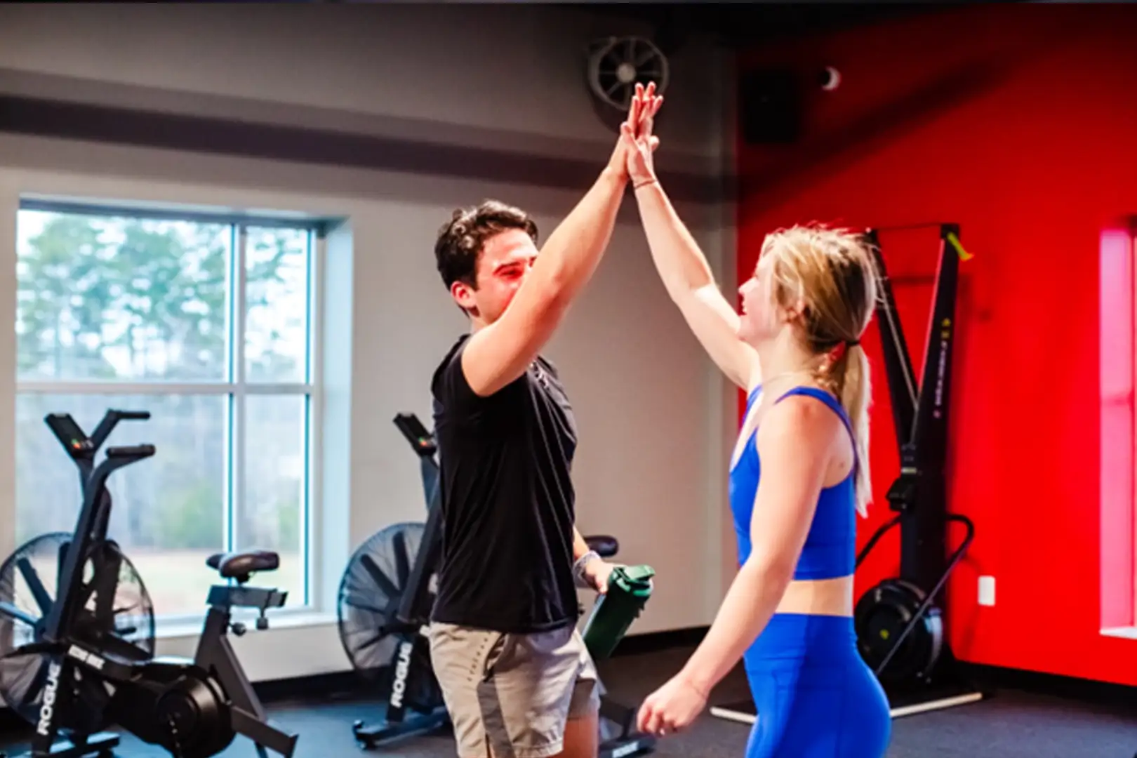 ceremony-les-mills_5 A personal trainer and client high-fiving.